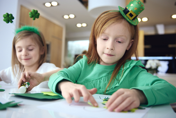 Portrait of siblings making ornament at Irish party